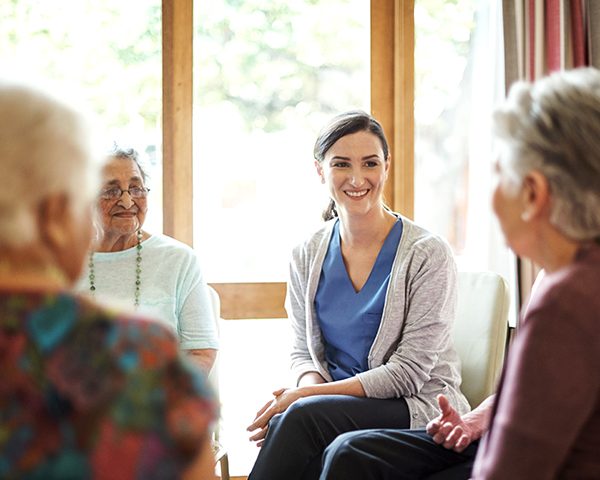 Photo of young woman with group of older women.